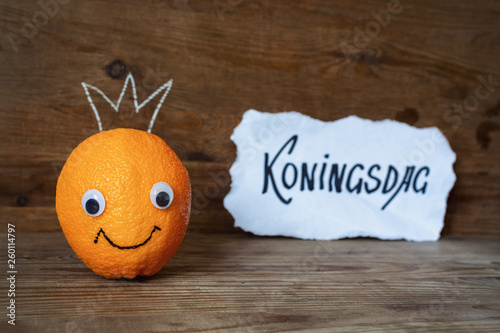 Smiling orange with a crown on his head. Holland traditional festival Koningsdag Kings day. photo