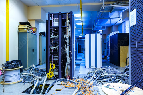 Obraz na plátne Server room with racks in datacenter and internet problem causing by disorder of wiring