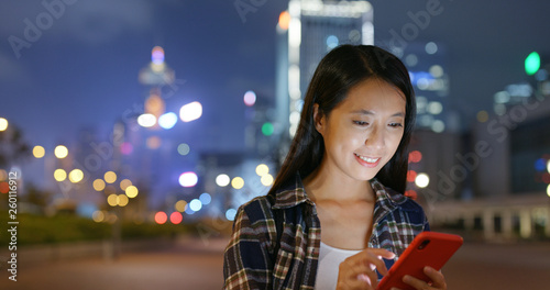 Photography Woman use mobile phone online in city at night