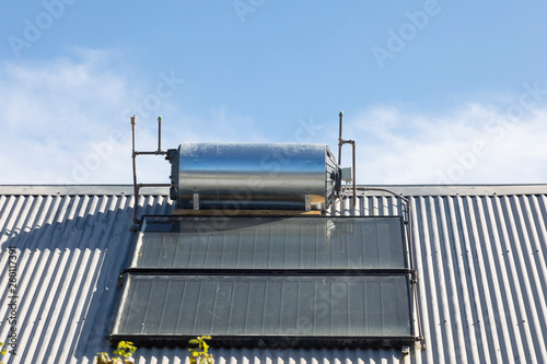 Fotografia Rooftop solar hot water cylinder with photovoltaic cells  on domestic house conv