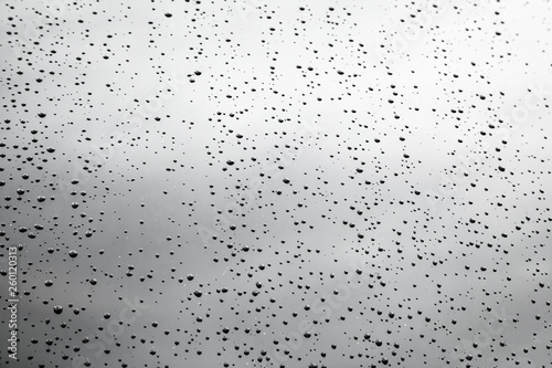 Raindrops on black color surface. Bad weather. Abstract picture for background and design. The drops of water are on the surface.