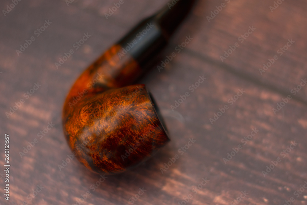 curved Smoking pipe with tobacco on the table curved Smoking pipe with tobacco on the table