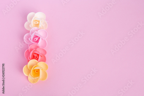 Waffle flowers on a pink background. Confectionery decor. The large plan. Macro.