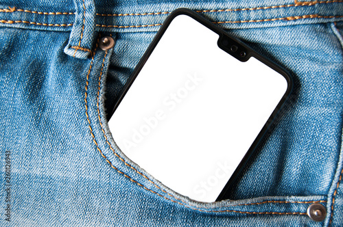 Smartphone with isolated white screen in a denim jeans pocket photo