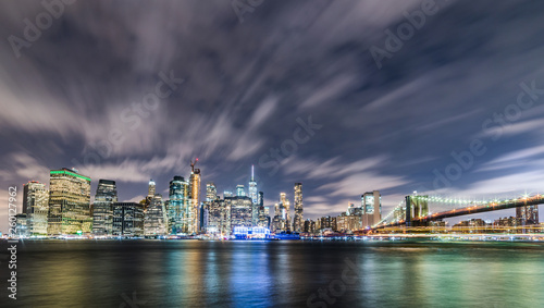 Manhattan panoramic skyline at night with Brooklyn Bridge. New York City  USA. Office buildings and skyscrapers at Lower Manhattan  Downtown Manhattan ..