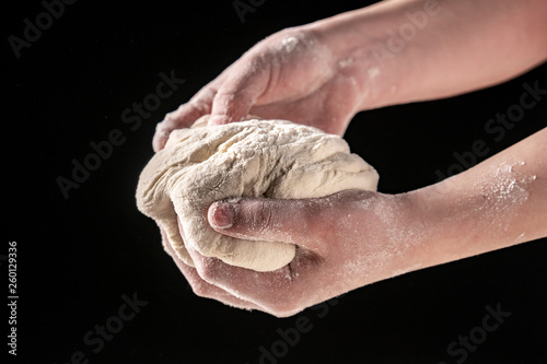 Making dough by female hands at bakery