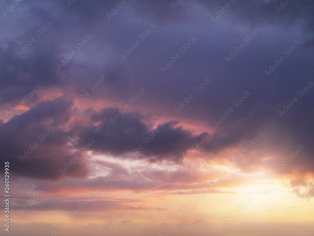 Clouds with sun, orange purple colors.