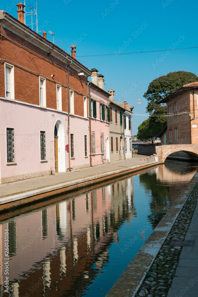 canal, bridge and colorful houses in Comacchio, Italy