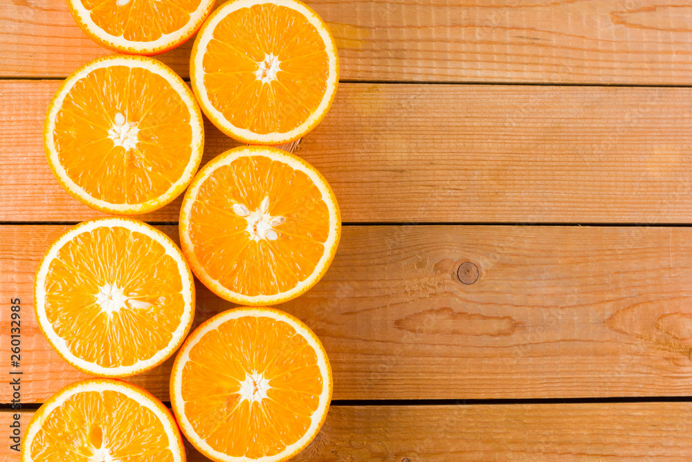 Oranges fruit on wooden boards. Halves of juicy orange on wooden background. Orange fruit, citrus minimal concept. Top view, copy space Oranges fruit on wooden boards. Halves of juicy orange on wooden background. Orange fruit, citrus minimal concept. Top view, copy space