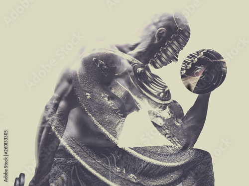 Double exposure of Brutal strong athletic bodybuilder with a heavy dumbbell.Bodybuilding and healty life concept. Copy space for sport nutrition ads