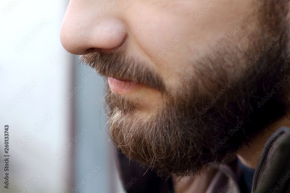 Profile portrait of brutal adult working man after labor day with a beard close up Profile portrait of brutal adult working man after labor day with a beard close up
