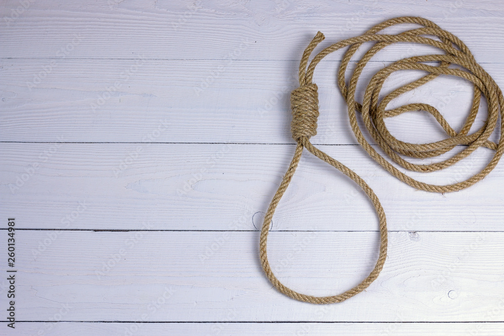 Hanging noose. Rope with loop. Rope with knot and loop on white wooden background. Hanging noose. Rope with loop. Rope with knot and loop on white wooden background.