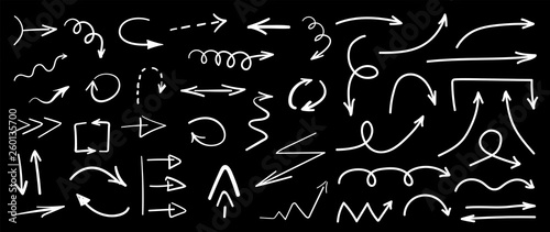 Set of white grunge hand drawn arrows isolated on black. Vector illustration