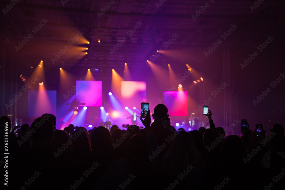 many people who dance and record with the phones at the live music concert