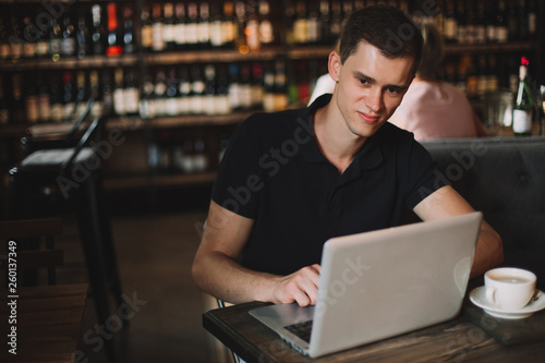 Businessman working on a laptop in a cafe.