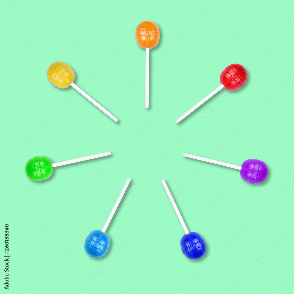 Set of colorful lollipops grouped in a circle isolated on green background. Set of colorful lollipops grouped in a circle isolated on green background.