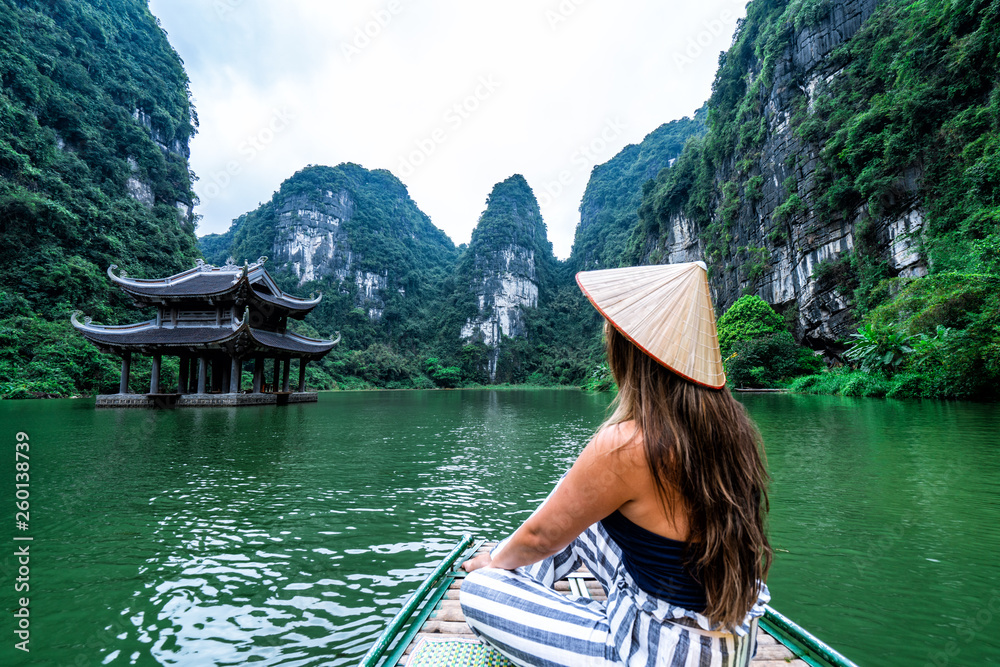 A woman on a river boat in Ninh Binh. Mountains of northern Vietnam.