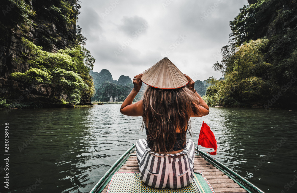 A woman on a river boat in Ninh Binh. Mountains of northern Vietnam.
