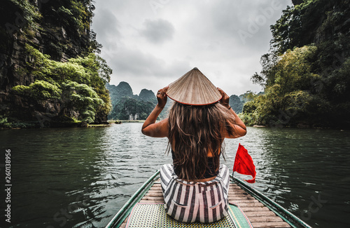 A woman on a river boat in Ninh Binh.  Mountains of northern Vietnam. photo