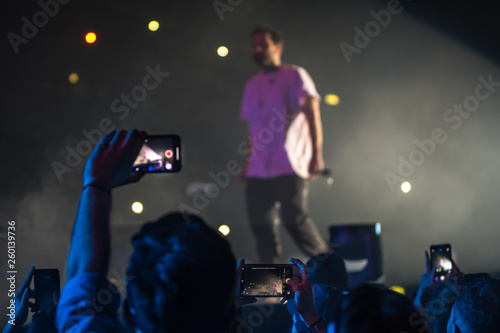 many people who dance and record with the phones at the live music concert