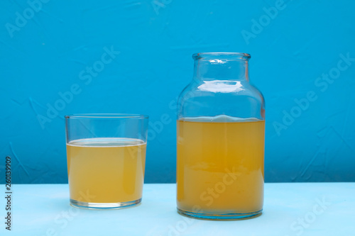 Fermented kombucha tea in a jar on blue background. Detox drink.