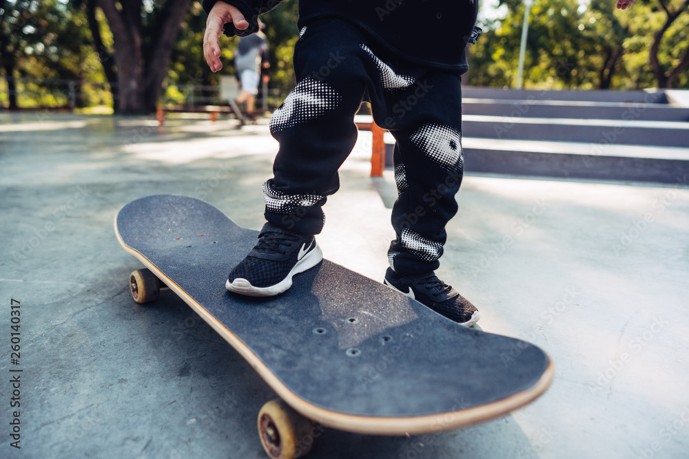 Fototapeta premium Boy legs on the skateboard close up image