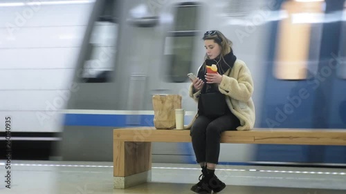 woman eating fast food in the subway