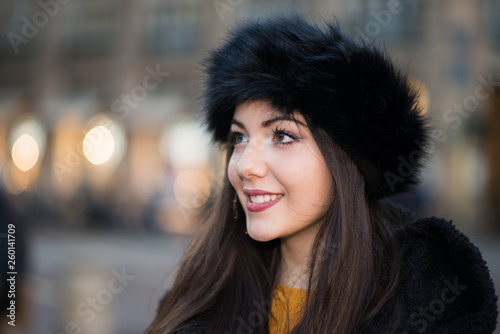 Young woman walking in a city at winter