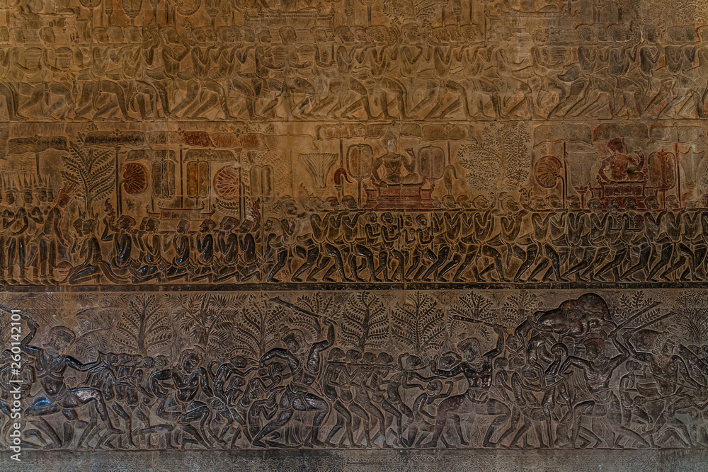 Wall carvings of Angkor Wat, Siem Reap background