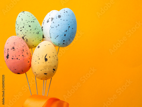 bouqued from color easter eggs on yellow background, copy space photo