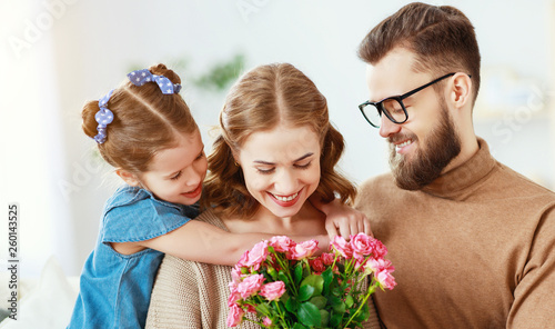 happy mother's day! father and child congratulate mother on holiday  .