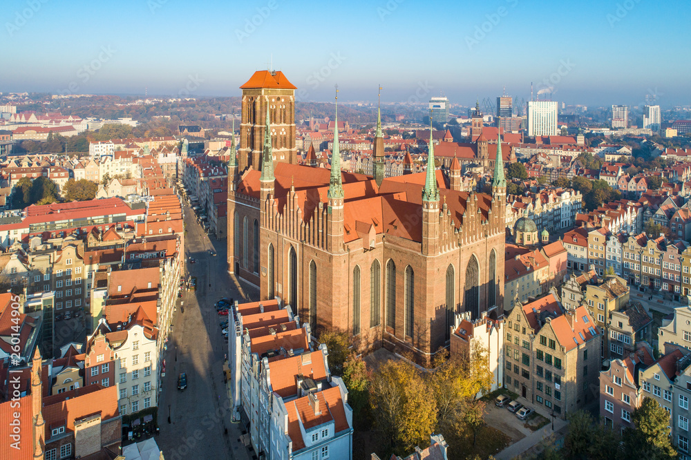 Gdansk old city in Poland with medieval Gothic Saint Mary Cathedral . Aerial view in sunrise light. Early morning