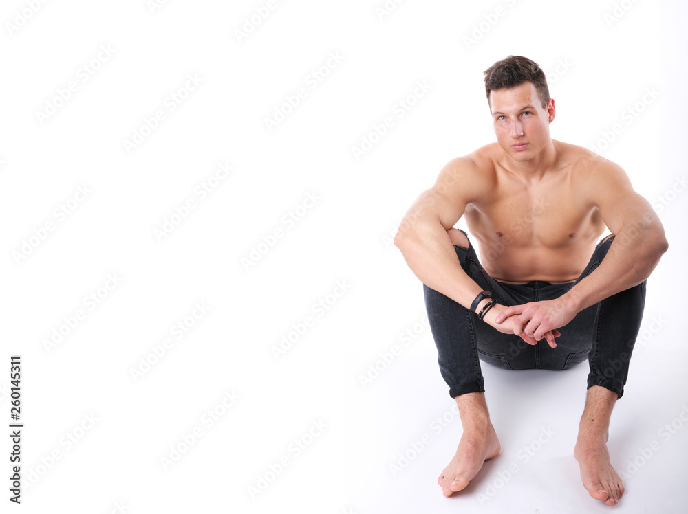 Nice, young adult man posing in a studio. Nice, young adult man posing in a studio.