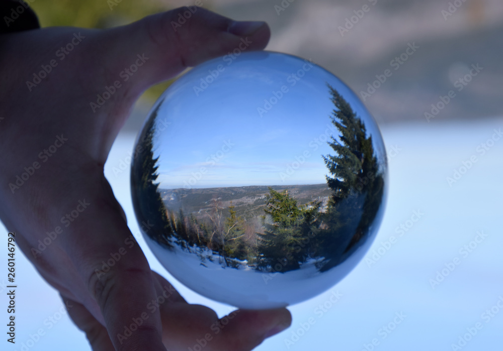 Winter mountains landscape in crystal ball.