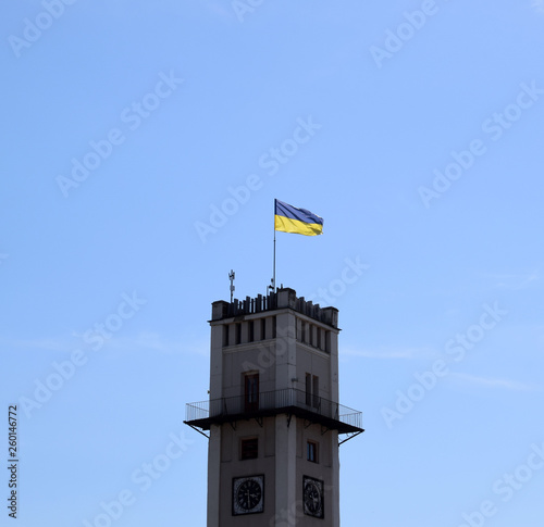 Clock Tower of Kolomyia City Council with ukrainian national flag.