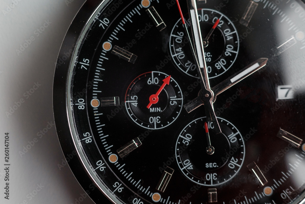 Close up front view of a modern wrist watch on the table. Soft focus. Close up front view of a modern wrist watch on the table. Soft focus.