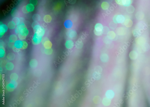 Bright White bokeh with green, blue, and yellow defocused shining lights.