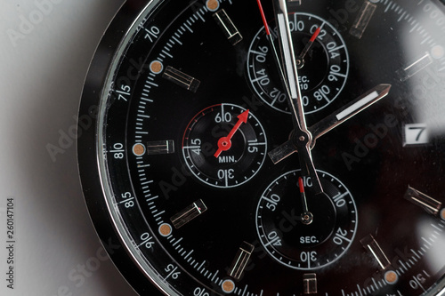 Close up front view of a modern wrist watch on the table. Soft focus. 
