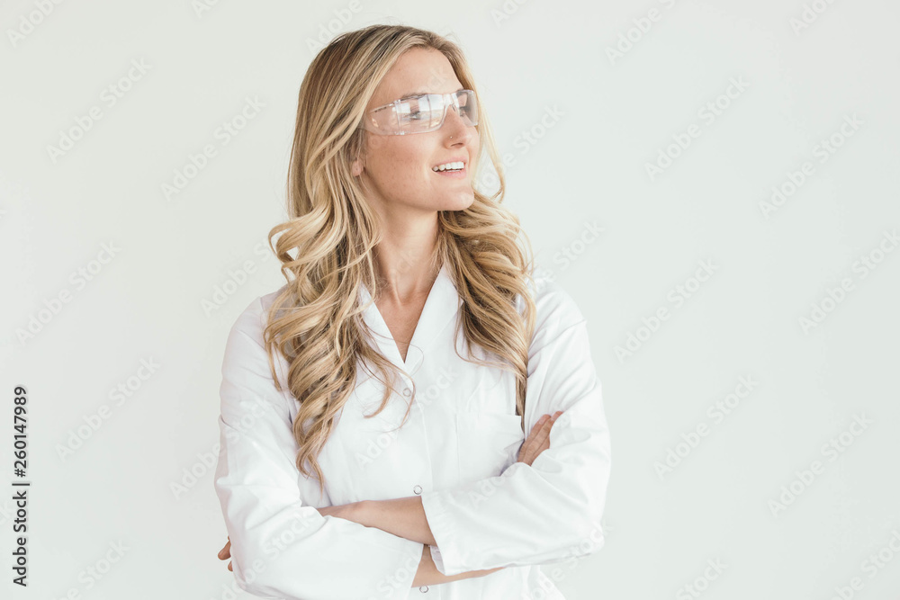 Happy Female Scientist or Doctor Wearing White Lab Coat and Protective Glasses Happy Female Scientist or Doctor Wearing White Lab Coat and Protective Glasses
