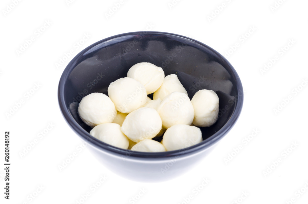 Small white mozzarella balls in black bowl. Small white mozzarella balls in black bowl.