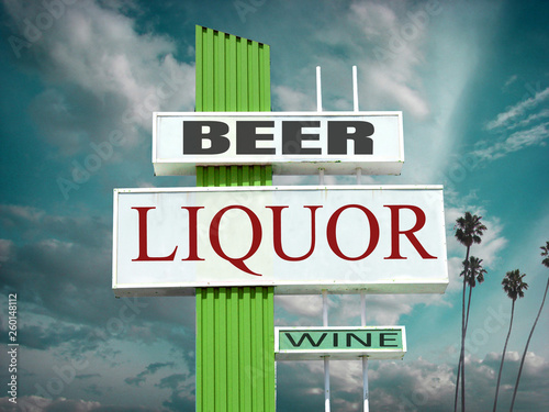 Aged and worn liquor beer and wine sign with palm trees photo