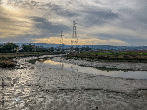 San Francisco Bay Marshland With Power Pylons at Low Tide on a Cloudy Day  photo