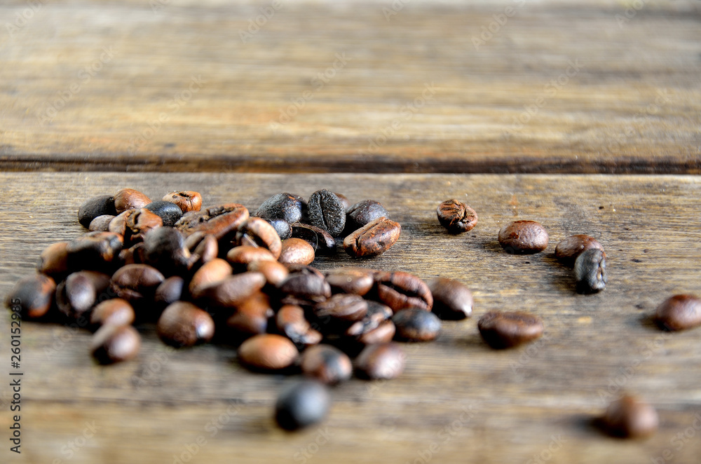 Fototapeta premium Roasted coffee grains on wooden boards.