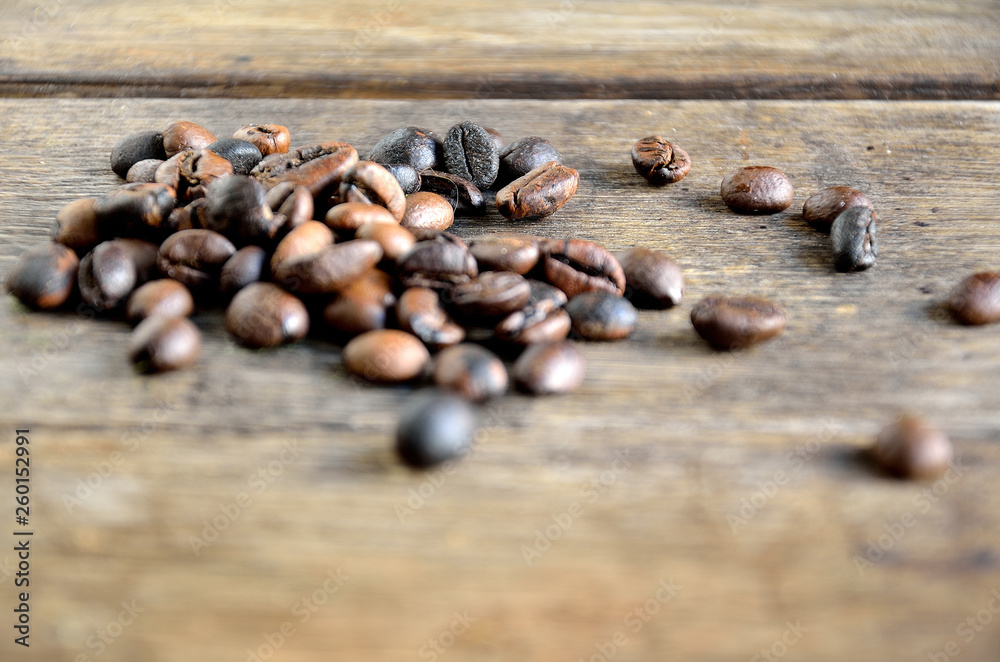Roasted coffee grains on wooden boards. Roasted coffee grains on wooden boards.