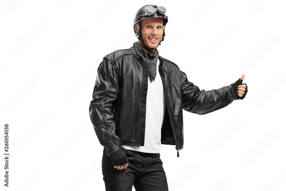 Young biker hitchhiking with his thumb up Young biker hitchhiking with his thumb up
