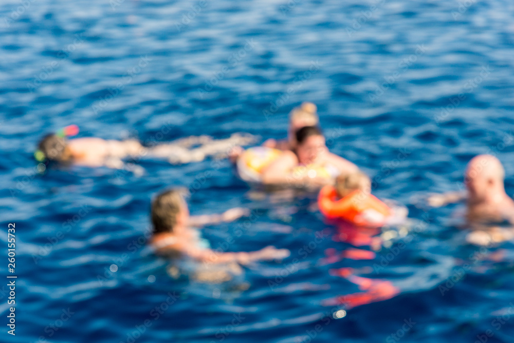 Recreation and sports, several people snorkeling in the blue sea, photos out of focus