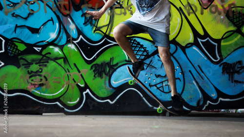 Skater do it trick on ghetto graffiti background