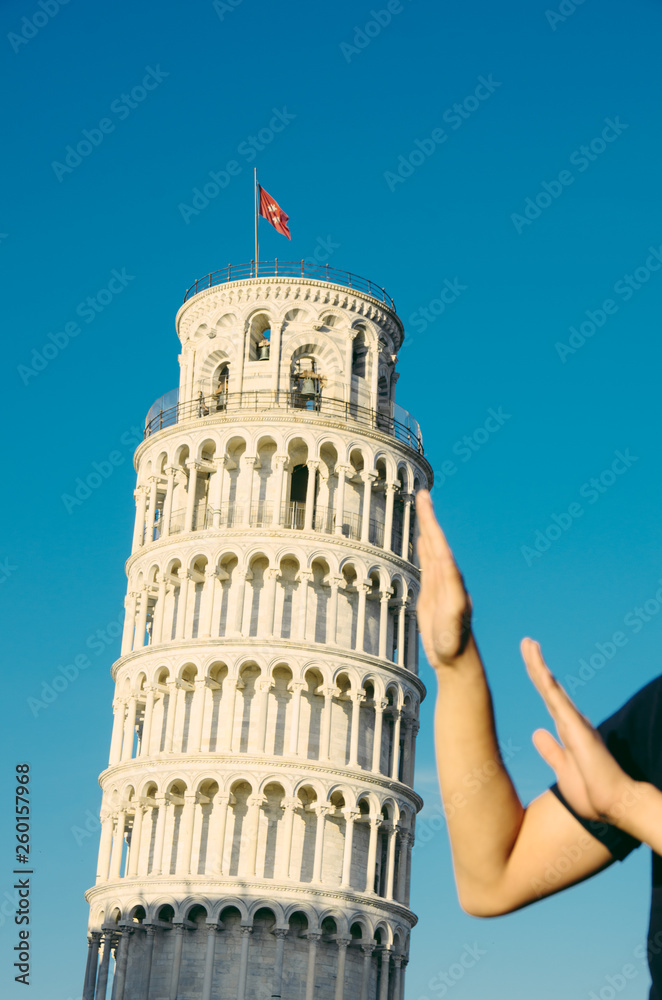 Fun. Hand leaning tower of Pisa typical photo made by tourists