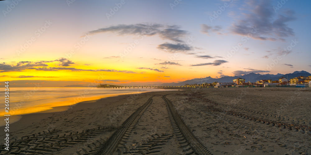 Tractor tyre tracks in beach sand