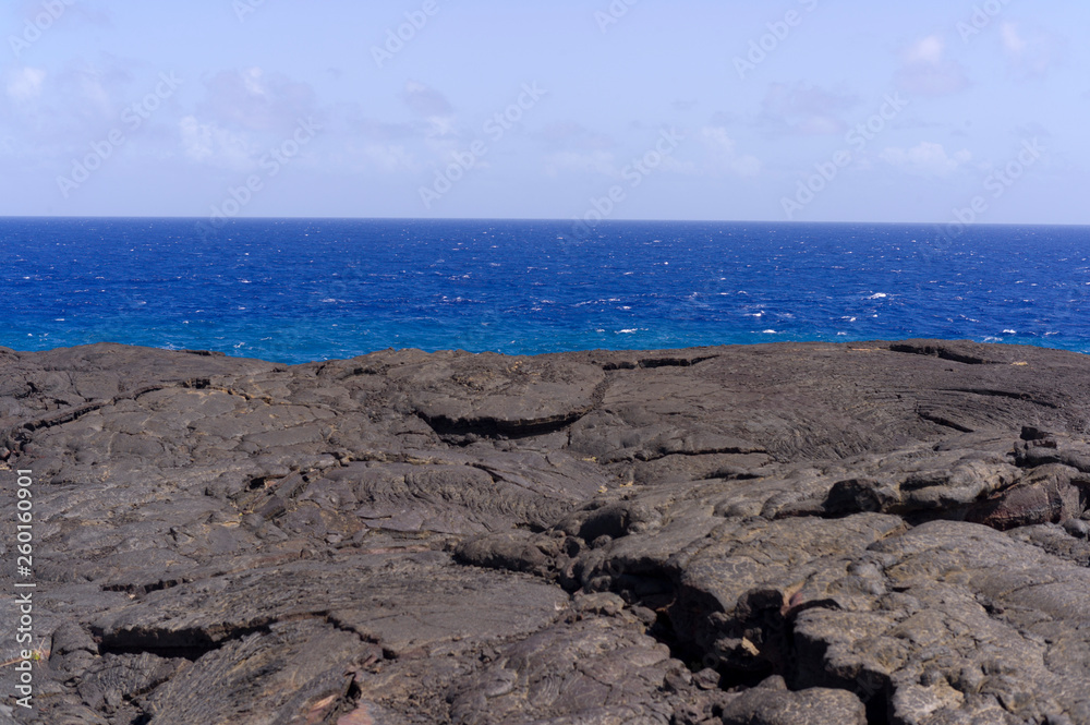 Horizon with deep blue ocean, lava rock and blue sky with clouds in Big Island, Hawaii Horizon with deep blue ocean, lava rock and blue sky with clouds in Big Island, Hawaii